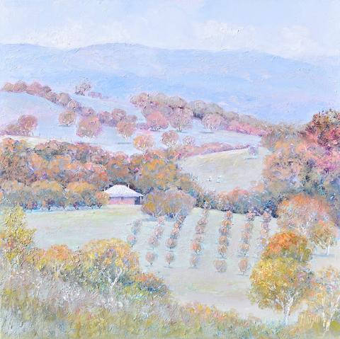 This autumn landscape painting is a tranquil scene, rendered in calming tones of soft blue, green and autumn tones. Nestled amidst the gently rolling hills is a farmhouse. On the foreground of this country scene, is an orchard, adding a sense of tranquility to the scene. There are distant blue hills and rows of gum trees.