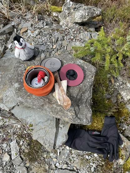 Small camping pot with stove inside, a coffee filter, and Penguin.