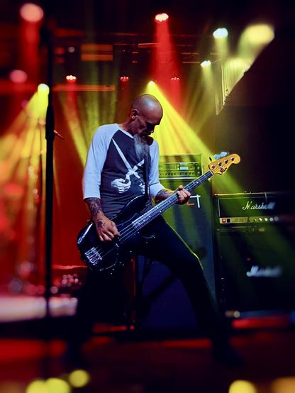 Mondo Generator's Nick Oliveri plays his bass live on stage 2023.