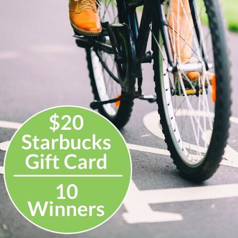 Photo of a bicycle passing over the bike symbol on a bike path. Text reads: $20 Starbucks gift card. 10 winners.