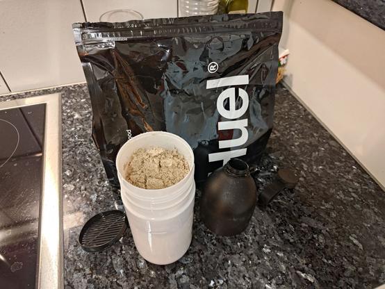 Huel package with huel shaker prepared to be shaken.