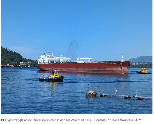 Tugs wrangle an oil tanker in Burrard Inlet near Vancouver, B.C.