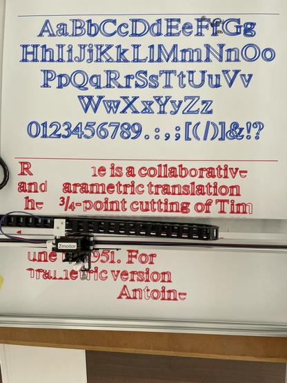 A plotter plotting the poster. 
In blue at the top:
All characters that were drawn: A-z plus numerals.

Below in red: a specimen text being drawn. The pen plotter is at works.