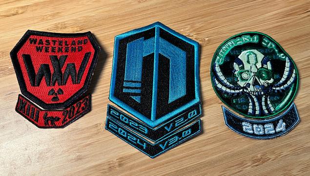 Three sets of sew-on patches with year chevrons below them. The first two sets indicate attending Wasteland Weekend in 2023 and Neotropolis in 2023 and 2024. The third indicates 2024 but has a more obscure meaning...