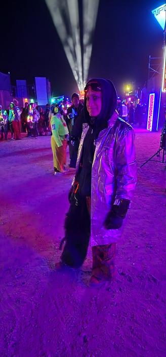 My outfit, I am wearing dust goggles, a mask is around my neck, I have a hood covering my head. I have a silver jacket, and two colored pants in black and a red tartan.