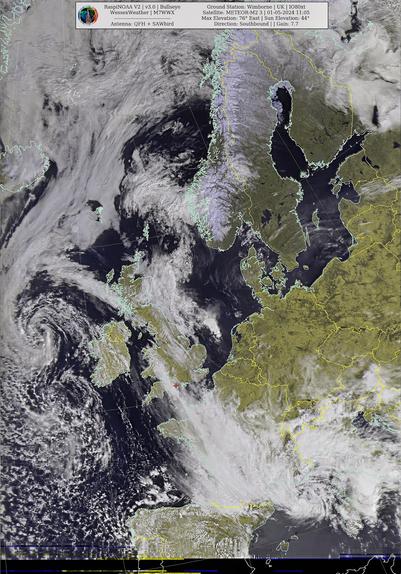 Satellite image of cloud cover over Europe, with text overlay detailing satellite and ground station information.