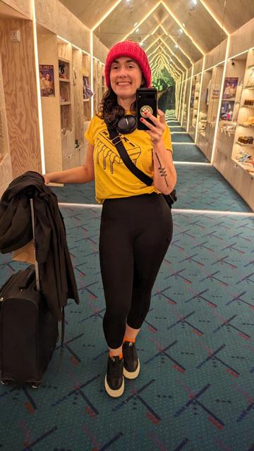 Helen in oskitone t-shirt on Portland airport carpet