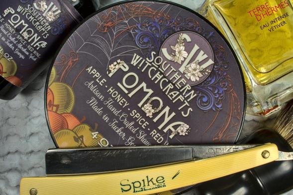 A Spike straight razor on a set of SW Pomona soap and splash next to a bottle of TdH Eau Intense Vétiver