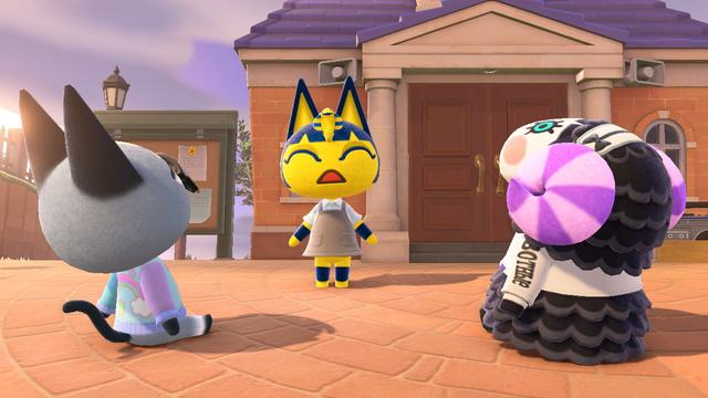 Animal Crossing: New Horizons screenshot. Set in the plaza near the town hall, Ankha (yellow cat with a blue Pharaoh style headdress with a snake in the middle built into her head) is singing with her eyes closed and Raymond (grey cat with glasses wearing a dreamy sweatshirt) and Muffy (black sheep with purple striped horns and a white face wearing a white jacket) is sitting down and listening to her intently.