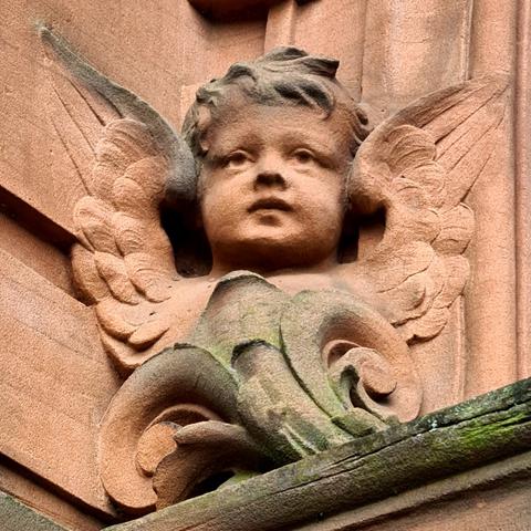 A putti carved from red sandstone.