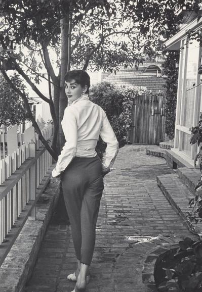 Black and white photo of Audrey Hepburn wearing Capri pants and a wrap collared shirt… which ironically actually currently working on 1 year later