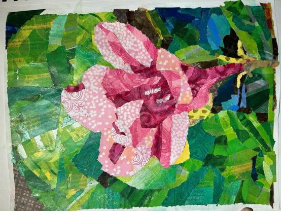 Paper collage of a flower in pinks on green leaves, with little bits of brown background showing through.