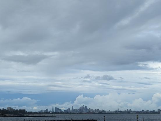 Sydney's metropolitan skyline seen across the bay harbour on a grey rainy day