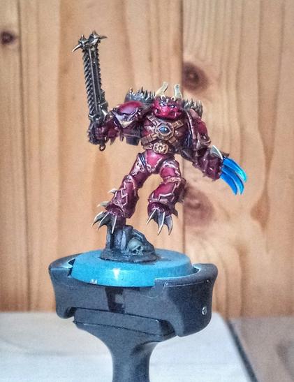 Nearly finished miniature of a Word Bearers Raptor in midjump.
