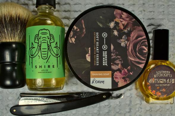 Top view onto a shiny Rolli razor next to a tub of BaM Roam, a bottle of Mammoth Shire splash, SW Autumn Ash frag and a Dogclaration mystery B16