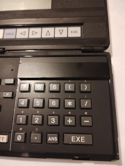 Casio PB-1000 pocket computer, close up of the numeric keypad showing a cover obscuring the tomorrow of buttons