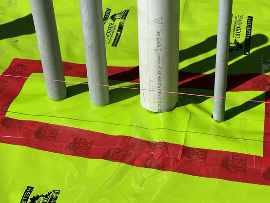 We cut patches to fit around the pipes and conduit as tightly as possible.