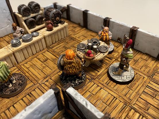 adventurers enjoying a rowdy meal, unaware of the impending goblins