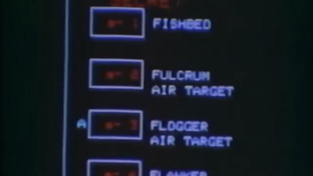 Still frame of a video showcasing the F-14 Central Air Data Computer (CADC). The screen shows the red text ”TARGET” above four numbered boxes with the following labels: “Fishbed”, “Fulcrum Air Target”, “Flogger Air Target”, “Flanker”. The letter “A” appears next to the box for the Flogger.