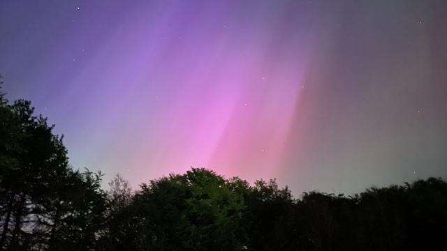 An image of an aurora captured on the 10th of May 2024. The aurora in the image is blue, red, green, and violet.