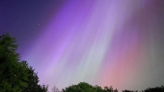 An image of an aurora captured on the 10th of May 2024. The aurora in the image is blue, red, green, and violet.