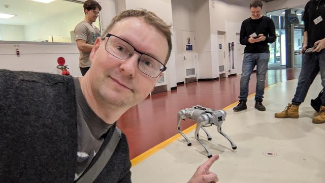Poster pointing at a small robot dog. We are on the technical floor of the Australian Synchrotron.
