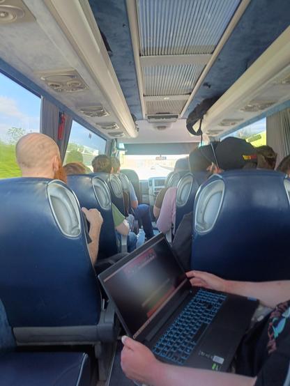 Photo from the back seat of a large minibus during daytime on the Irish M6.