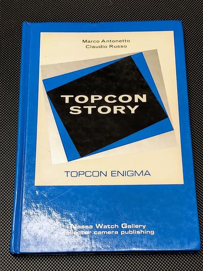 Hardcover book by Marco Antonio and Claudio Russo, Topcon Story. In topcon official blue and grey colors