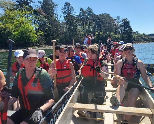 Two dragonboats, with crew, side by side