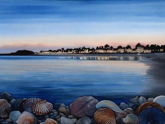 Coastal village on blue evening with lights coming on, viewed across a calm bay, with a collection of colorful seashells in the foreground. Watercolor style.