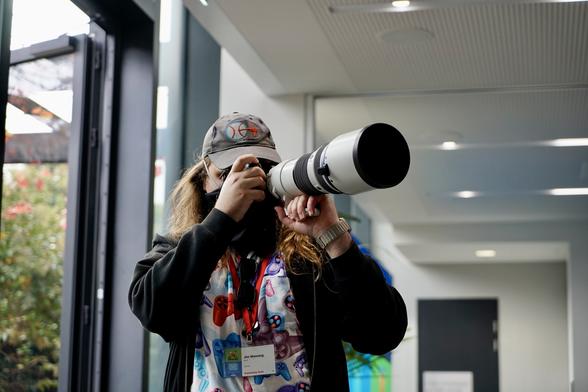 Jon is taking a photo using an approximately 12 metre long zoom lens.