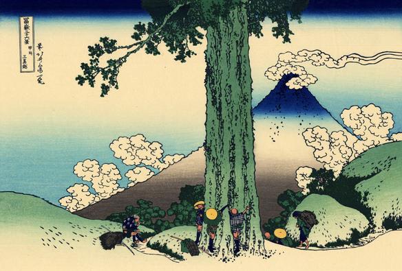 Travelers hug a giant tree with Mt Fuji in the background