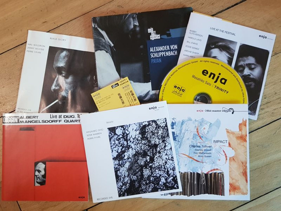 assembly of CDs and CD booklets on wooden floor: Mal Waldron, "Black Glory"; Alexander von Schlippenbach, "Payan"; Various, "Live at the Festival"; Albert Mangelsdorff Quartet, "Live in Tokyo" (aka "Diggin' - Live at Dug, Tokyo"); Masahiko Sato/Peter Warren/Pierre Favre, "Trinity"; Charles Tolliver/Stanly Cowell/Ron Mathewson/Alvin Queen, "Impact"