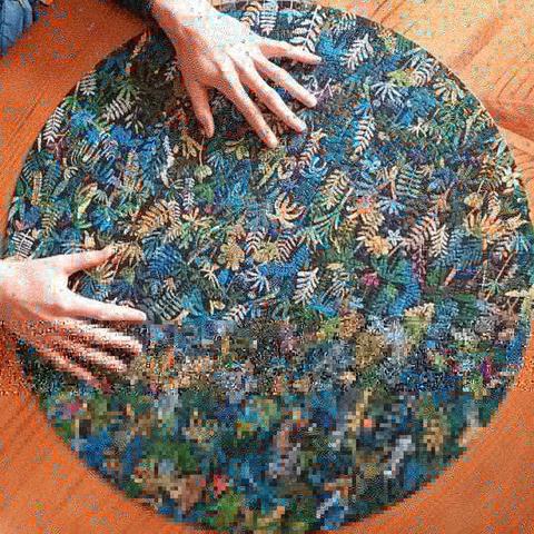 The completed puzzle with hands for scale