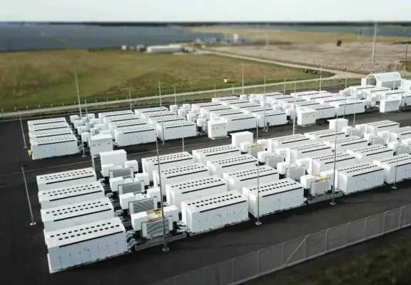Battery storage is about to overtake global capacity of pumped hydro. Photo with huge amount of containers full  of batteriesand inverters to feed the grid.