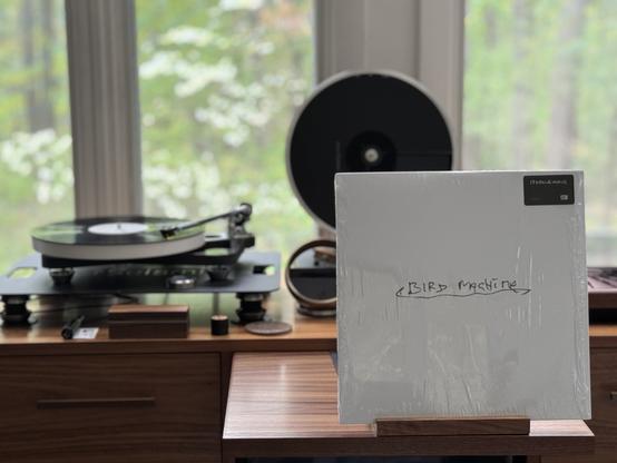Sparklehorse - Bird Machine LP cover.

A white cover with Bird Machine hand written in the middle, hand underlined.

The black LP plays on a Rega turntable to the left.