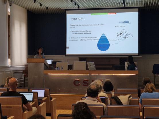Hatice Turk presenting modeling of water travel times using bucket-based conceptual model, focused on groundwater recharge.