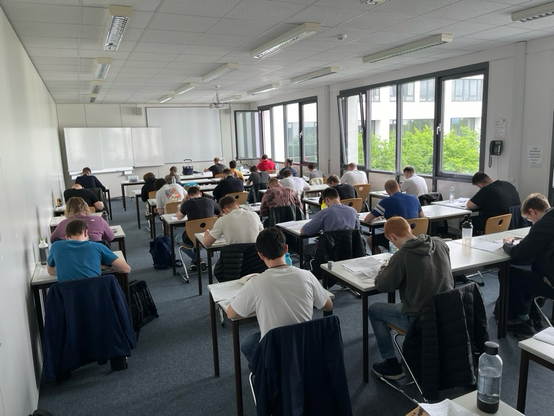 Class of students in an exam setup.