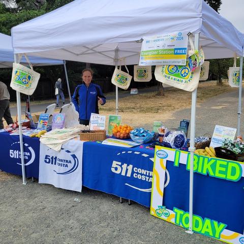 Photo of 511 Contra Costa's Energizer Station with a staff member standing behind the table.