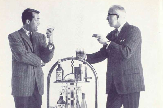 1957 Two Men in a Lab with Chemical Equipment

The image shows two men standing near each other in what appears to be a laboratory setting.
One man is wearing a suit and tie, while the other is dressed more casually, suggesting a professional or formal environment.
They seem to be engaged in some kind of discussion or experiment, as indicated by their focused expressions.