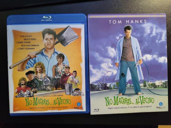 A photo of a Blu-ray, both the holster and the slip case.

On the left we see Tom Hans large in the bacground with various neighbors smaller in front of him.

On the right is the classic "Burbs" poster with Tom hans outside in a robe.