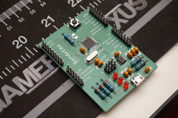 An Arduino built with mostly through-hole components.  The micro is an ATmega328PB, it has a micro USB conncetor on the bottom, and is a glorious shade of green.