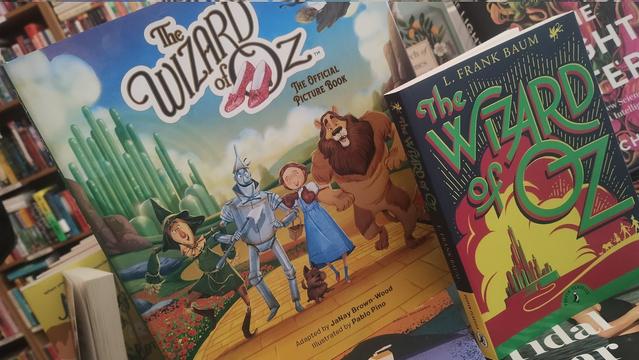 An illustrated and a regular paperback edition of L Frank Baum;s The Wizard of Oz, on a table in the Edinburgh Bookshop