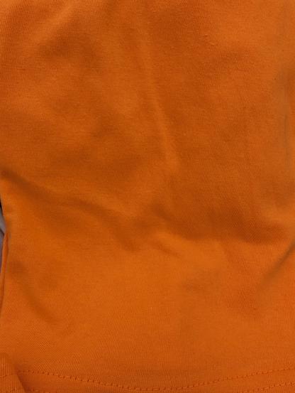 Close-up of t-shirt fabric. The entire image is orange.