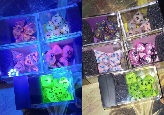 Two side-by-side pictures of the same 5 sets of dice, each in their plastic cubes. 
In the picture on the left, they are illuminated with UV light, so they glow with swirls of pink, orange, and purple. One set just glows green.
In the picture on the right, they are seen in normal light. They are various marbled shades of pink and purple. Some have blue streaks and one set has black swirls too. The set that was glowing green is a swirly green.