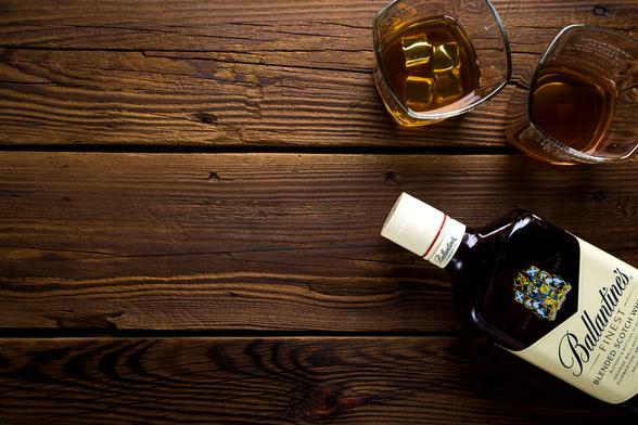 ballantine s bottle with two rock glasses