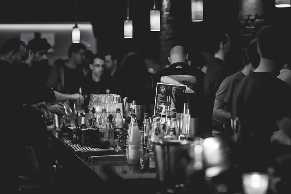 grayscale photography of bottles on top of table