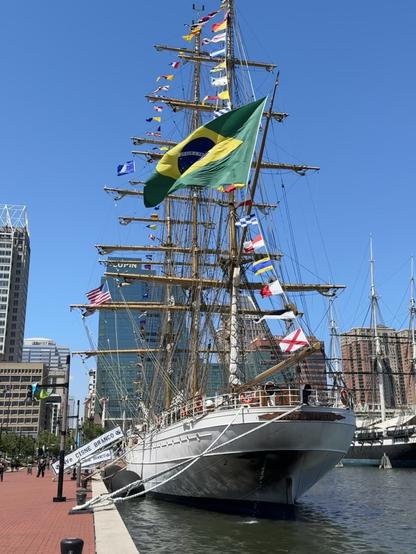The Brazilian tall ship, docked in Baltimore.

The ship is a brilliant white, with it's large Brazilian flag on the stern, and a very large number of flags and pennants running along the rigging from the bow, up to the top of the mast, and down to the stern.

It made a very pretty display (and was quite loud, in the wind)