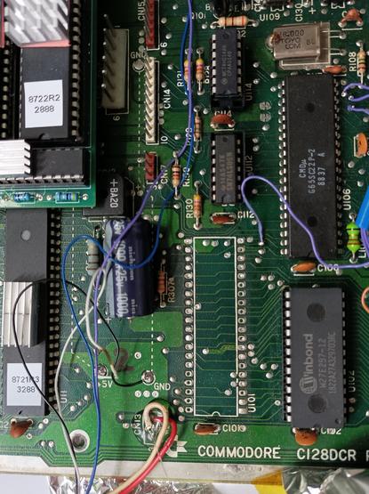 C128DCR mainboard with 6502 U101 removed.