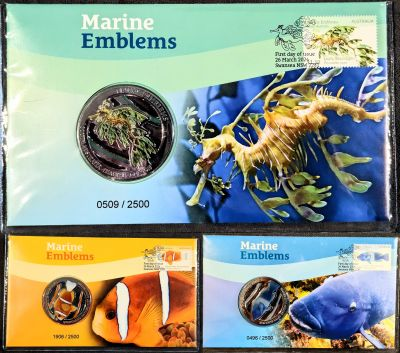 Front of the three PNCs showing stamps top-right, medallion mid-left, "Marine Emblems" title above and image of the emblem on the right. Top is South Australia's Leafy Sea Dragon in green and blue. Lower-Left Queensland's Barrier Reef Anemonefish in orange and yellow, and lower-right NSW's Eastern Blue Groper in blue